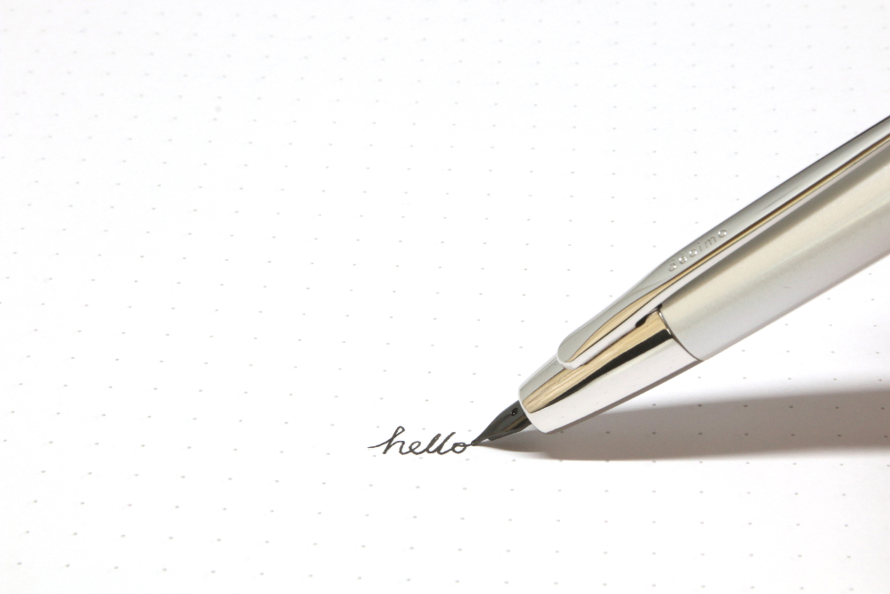 pen writing hello on paper